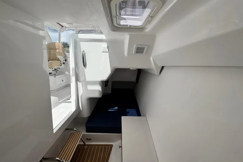 Slide: The Image of Interior cabin of 2026 Southport 33 DC boat, featuring seating and compact design. - 21