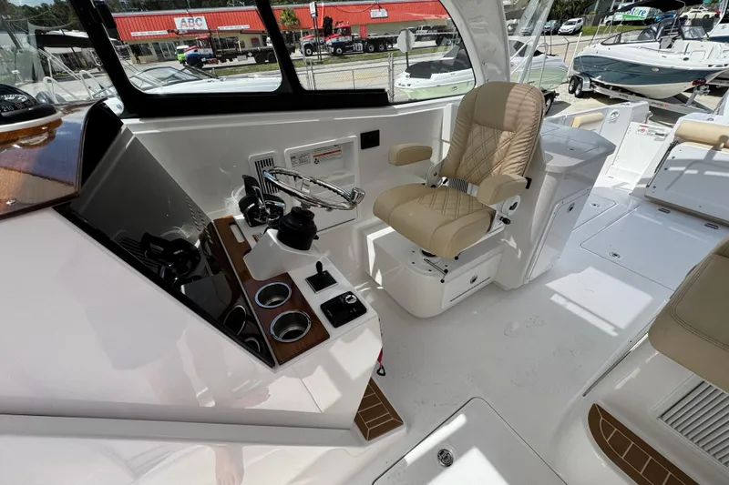 Slide: The Image of Interior of 2026 Southport 33 DC boat with helm, steering wheel, and captain's chair. - 25