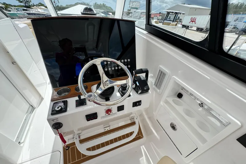 Slide: The Image of 2026 Southport 33 DC boat helm with modern controls and steering wheel. - 27