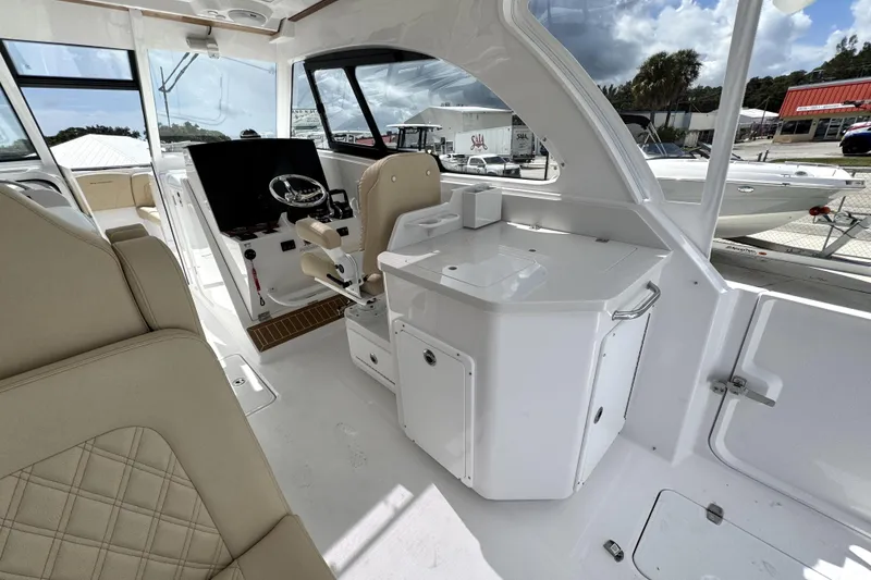 Slide: The Image of Interior of 2026 Southport 33 DC boat, featuring helm and seating area. - 29