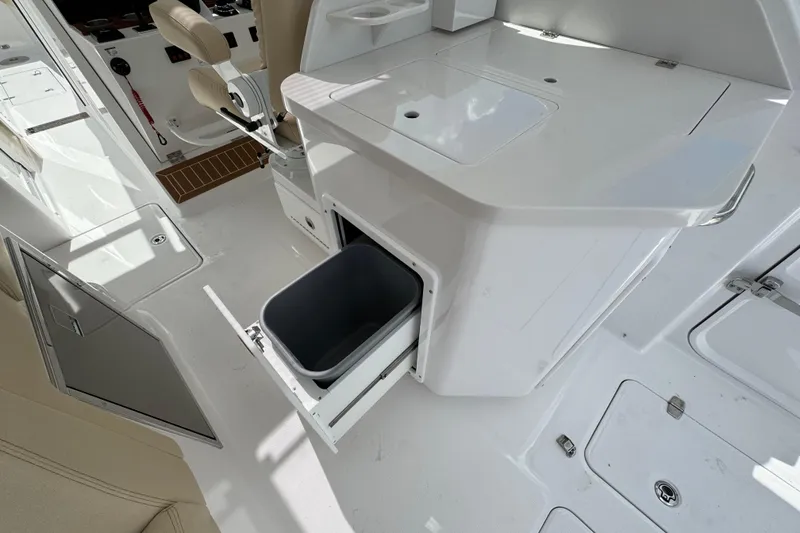 Slide: The Image of 2026 Southport 33 DC boat interior with storage compartment and seating. - 31