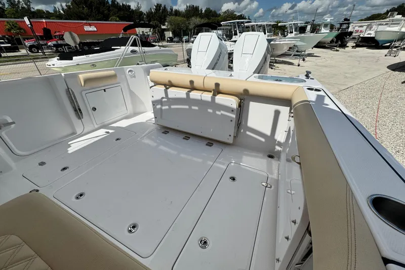 Slide: The Image of 2026 Southport 33 DC boat interior with seating and storage, displayed outdoors. - 34