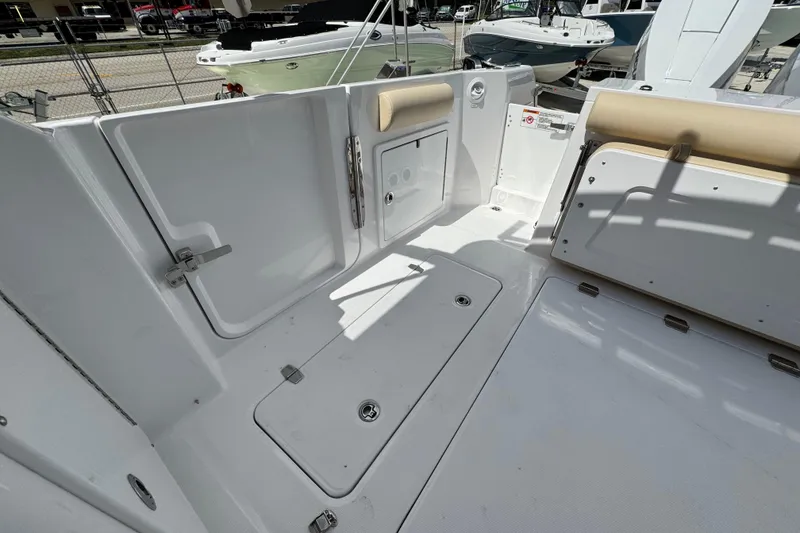 Slide: The Image of 2026 Southport 33 DC boat deck with storage compartments and seating. - 35