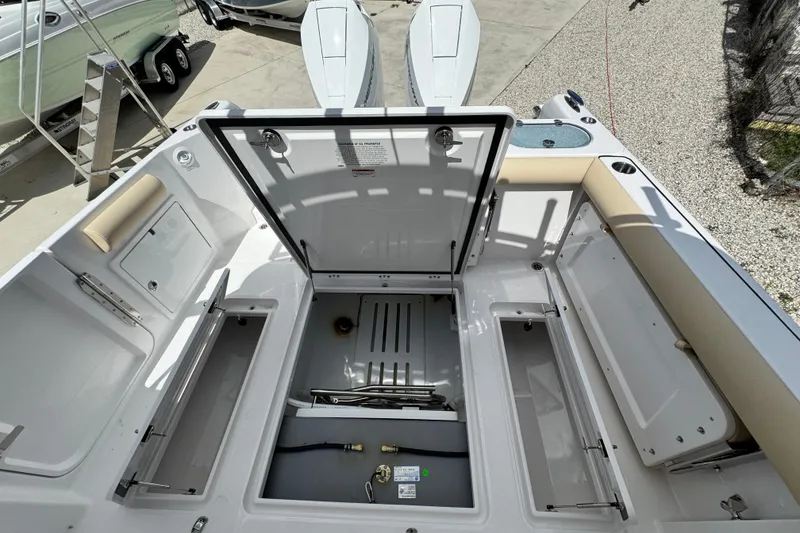 Slide: The Image of 2026 Southport 33 DC boat deck with open storage compartments and seating. - 36