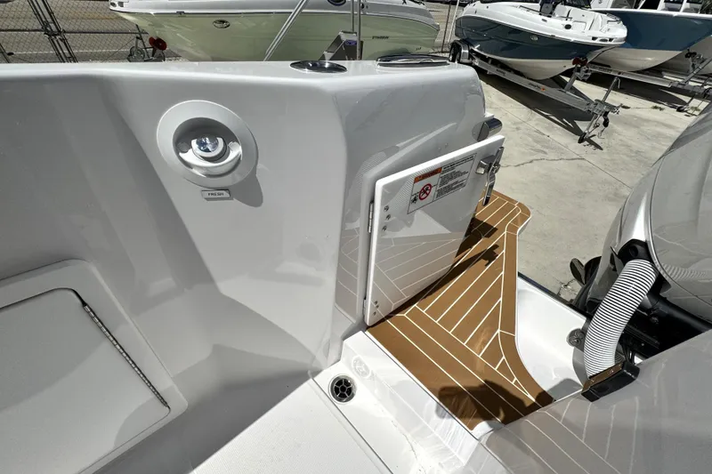 Slide: The Image of 2026 Southport 33 DC boat deck with teak flooring and fresh water access. - 42