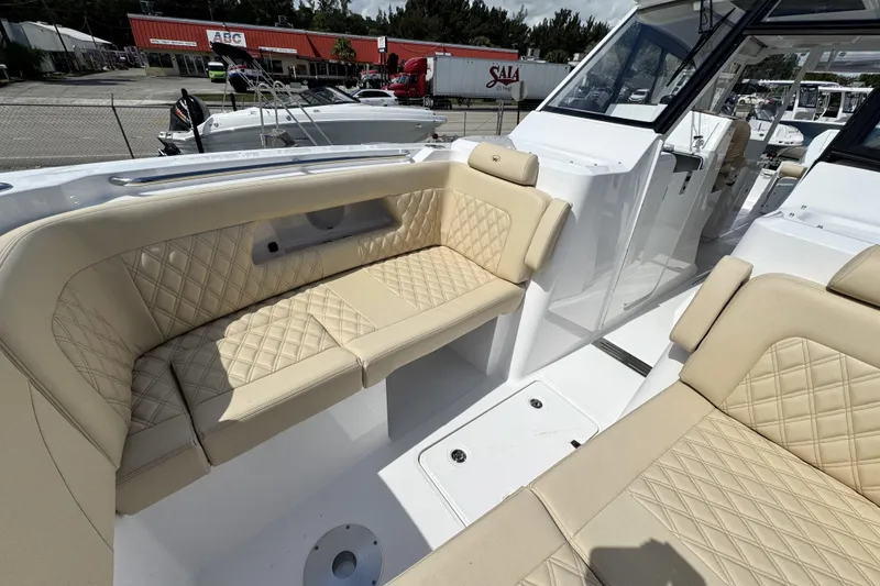 Slide: The Image of Luxurious seating on 2026 Southport 33 DC boat, featuring beige quilted upholstery. - 8