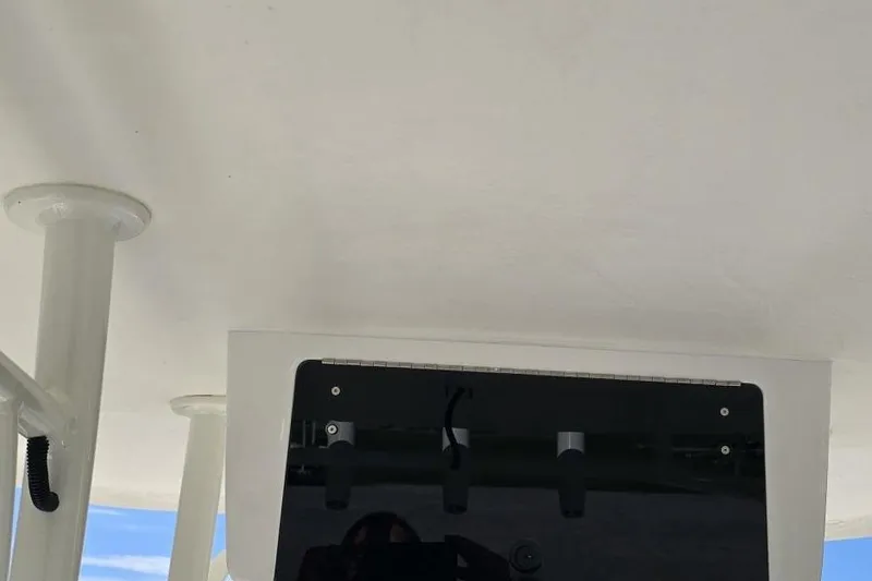 Slide: The Image of 2026 Sea Born LX21 Center Console boat interior with white ceiling and mounted equipment. - 10