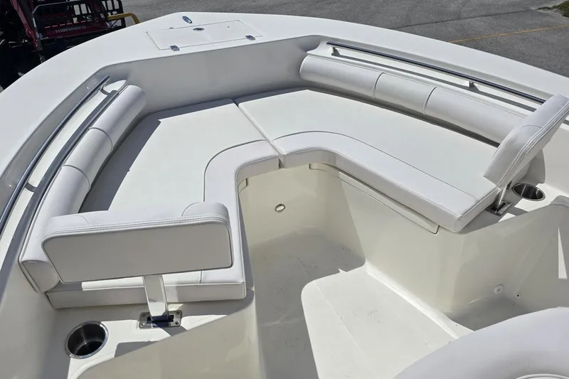 Slide: The Image of 2026 Sea Born LX21 Center Console boat with white cushioned seating and cup holders. - 16