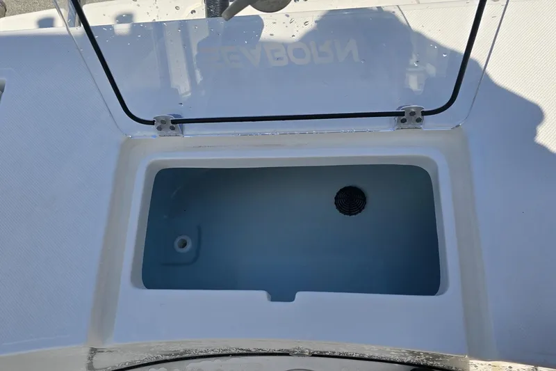 Slide: The Image of 2026 Sea Born LX21 Center Console livewell with open lid, showcasing interior design. - 5