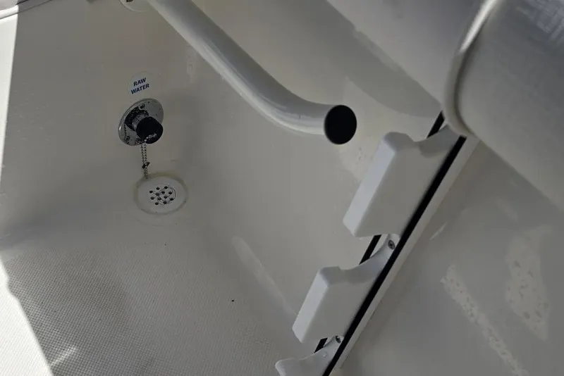 Slide: The Image of 2026 Sea Born LX21 Center Console interior detail with raw water outlet and drainage. - 6