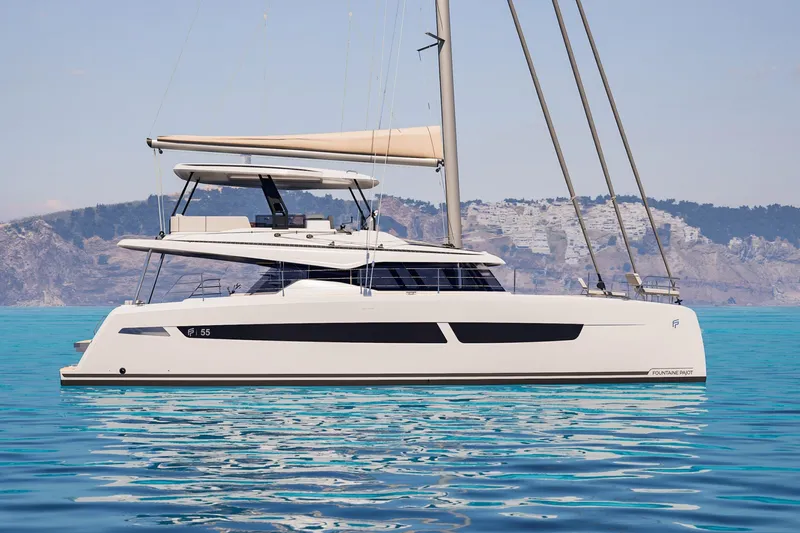 Slide: The Image of 2026 Fountaine Pajot 55 catamaran sailing on clear blue waters. - 16