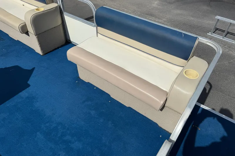 Slide: The Image of 1997 Crest 18 boat interior with blue carpet and beige seating. - 10