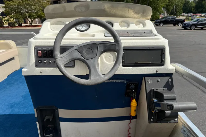 Slide: The Image of Steering console of a 1997 Crest 18 boat with blue carpet and control panel. - 15