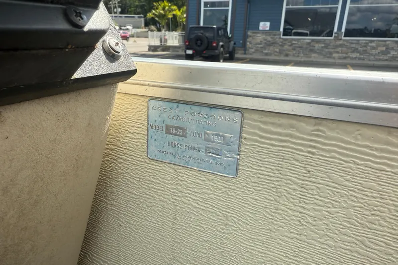 Slide: The Image of 1997 Crest 18 boat capacity plate, showing model and load information. - 16