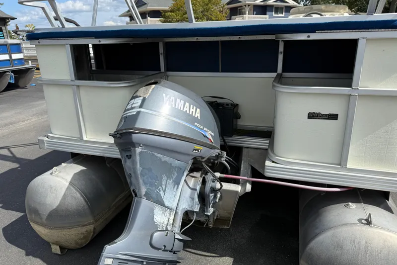 Slide: The Image of 1997 Crest 18 pontoon boat with Yamaha 25 outboard motor, docked outdoors. - 5