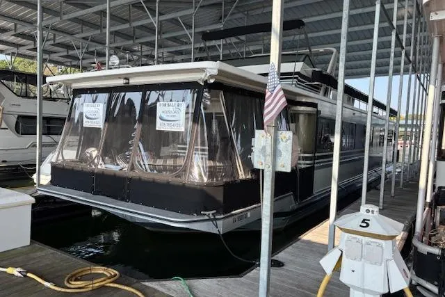 The Image of 1989 Sumerset 14x71 houseboat docked, covered, with "For Sale" signs displayed. - 0