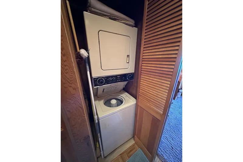 Slide: The Image of Stacked washer and dryer in 1989 Sumerset 14x71 houseboat laundry area. - 12