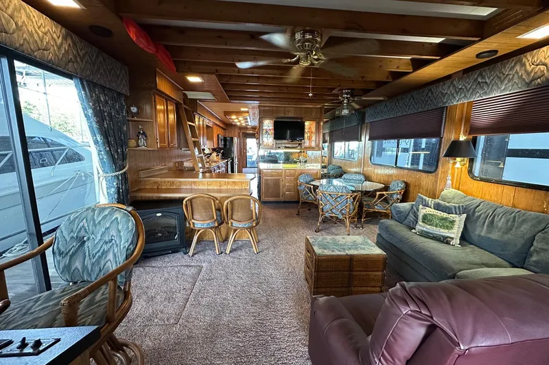 Slide: The Image of 1989 Sumerset 14x71 houseboat kitchen with wooden cabinets, stainless steel appliances, and double sink. - 3