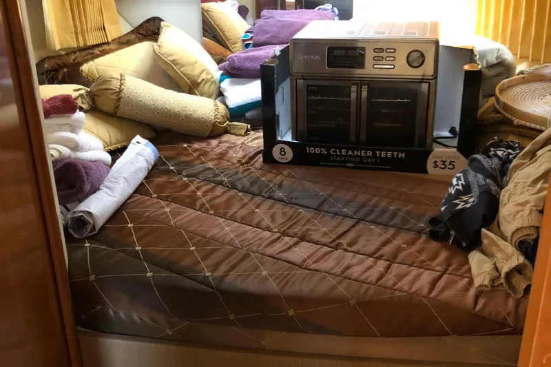 Slide: The Image of Cozy cabin interior of 2004 Carver 366 Motor Yacht with bedding and boxed appliance. - 11