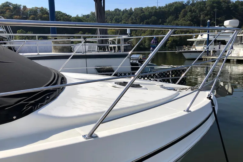 Slide: The Image of 2004 Carver 366 Motor Yacht docked, featuring sleek railings and a covered deck. - 2