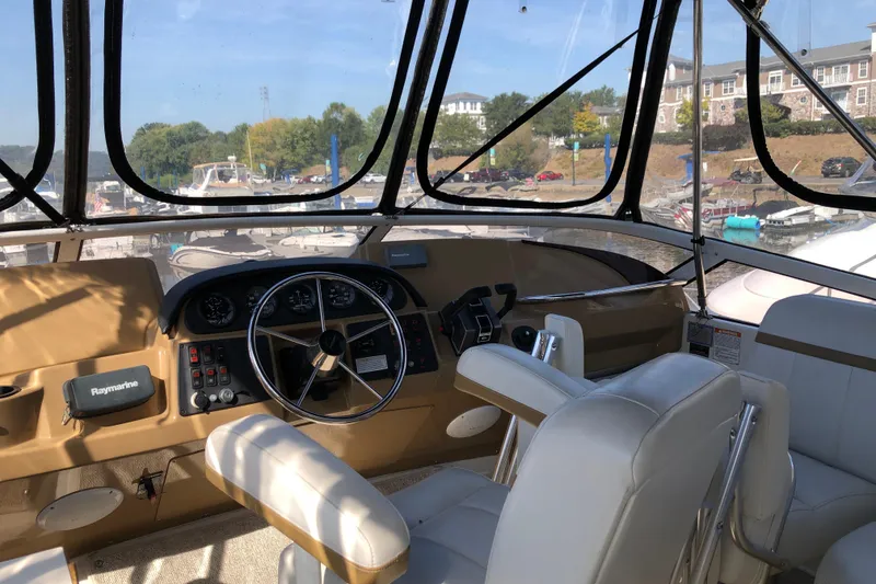 Slide: The Image of 2004 Carver 366 Motor Yacht helm with steering wheel and navigation equipment. - 27