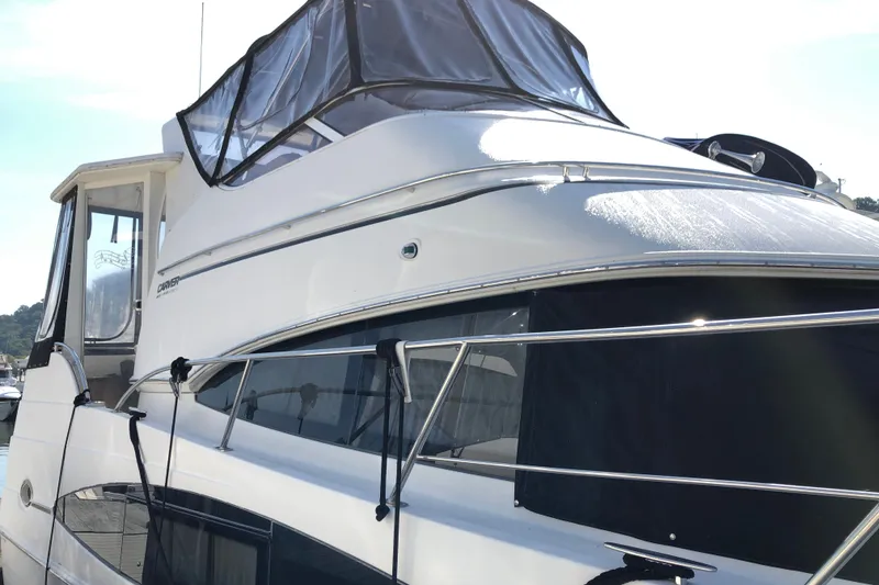 Slide: The Image of 2004 Carver 366 Motor Yacht with sleek design and modern features, docked in sunlight. - 3