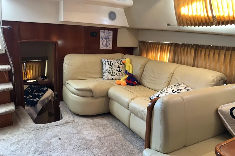 Slide: The Image of Luxurious interior of 2004 Carver 366 Motor Yacht with beige leather seating and nautical decor. - 8