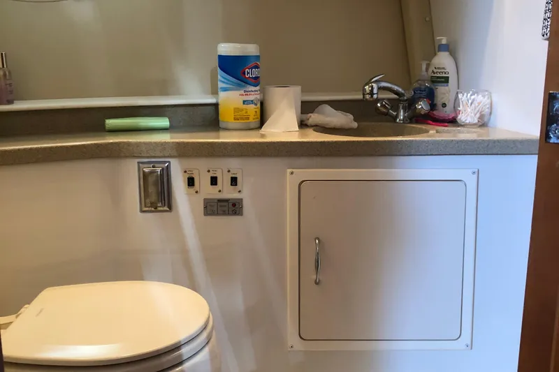 Slide: The Image of Bathroom interior of 2004 Carver 366 Motor Yacht with sink and cleaning supplies. - 10