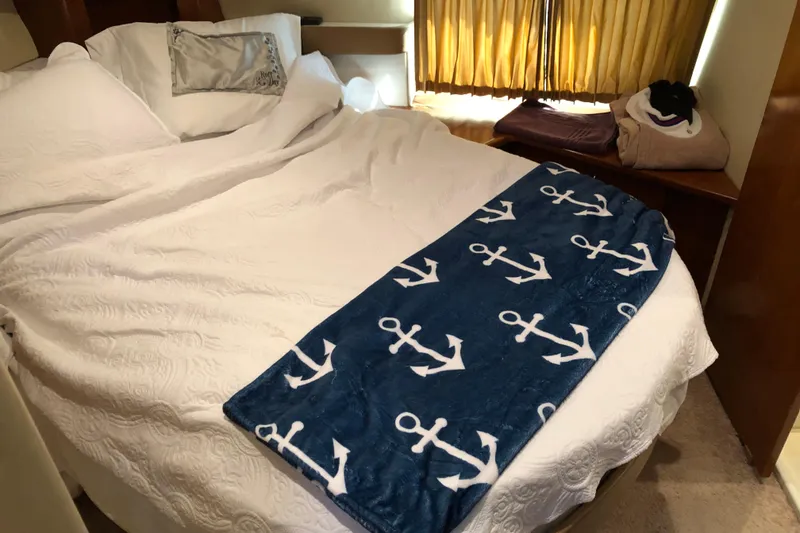 Slide: The Image of Cozy bedroom in 2004 Carver 366 Motor Yacht with nautical-themed blanket. - 13
