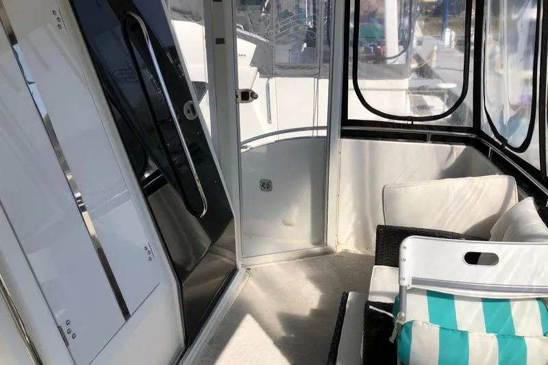 Slide: The Image of 2004 Carver 366 Motor Yacht interior with seating and glass doors. - 24