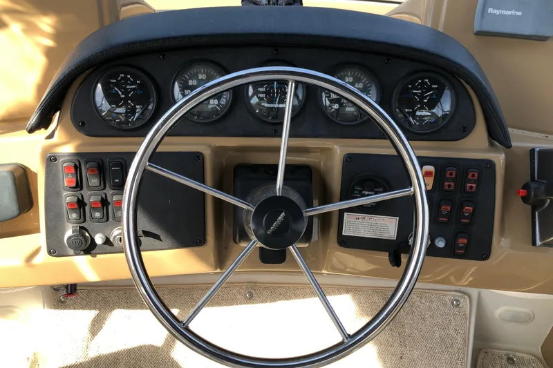Slide: The Image of Steering wheel and dashboard of 2004 Carver 366 Motor Yacht with gauges and controls. - 28