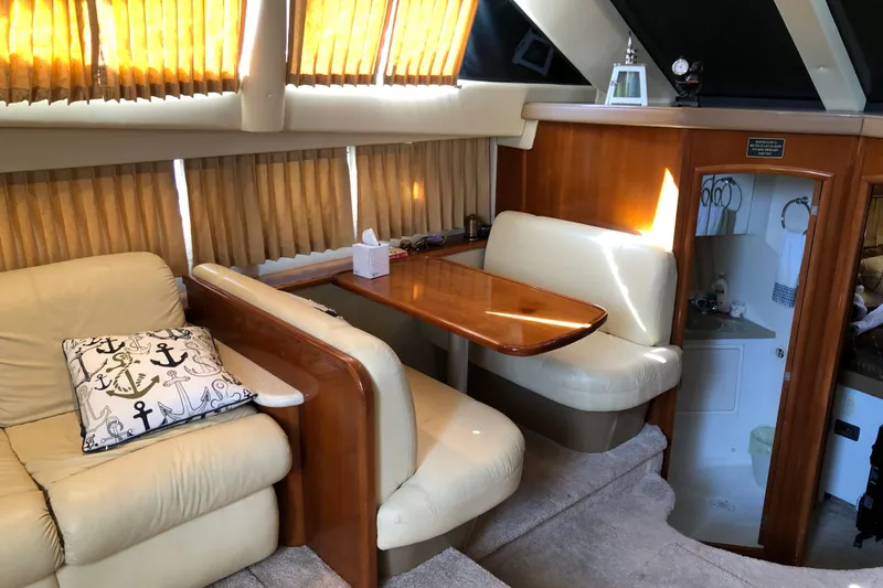 Slide: The Image of Interior of 2004 Carver 366 Motor Yacht with cozy seating and wooden table. - 7