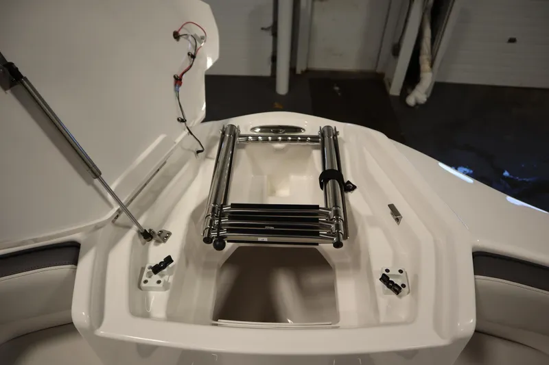 Slide: The Image of 2026 Yamaha Boats AR250 bow storage with stainless steel ladder and hydraulic lift. - 12