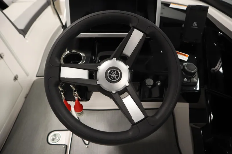 Slide: The Image of Steering wheel of 2026 Yamaha Boats AR250, featuring modern controls and sleek design. - 22