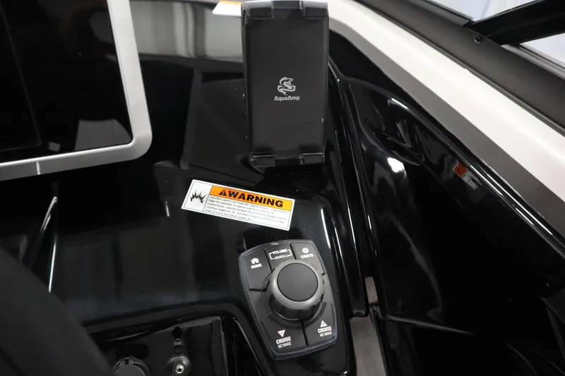 Slide: The Image of Control panel of 2026 Yamaha Boats AR250 with warning label and navigation controls. - 25