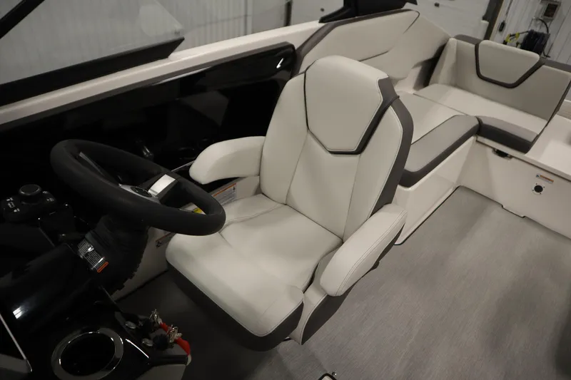 Slide: The Image of 2026 Yamaha Boats AR250 interior with sleek white seating and modern steering wheel. - 28
