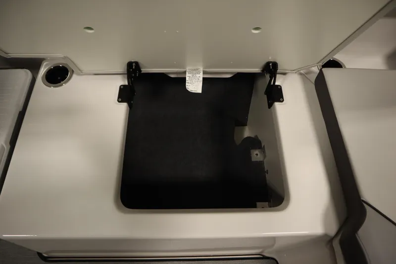 Slide: The Image of Open storage compartment on 2026 Yamaha Boats AR250, showcasing interior space. - 38