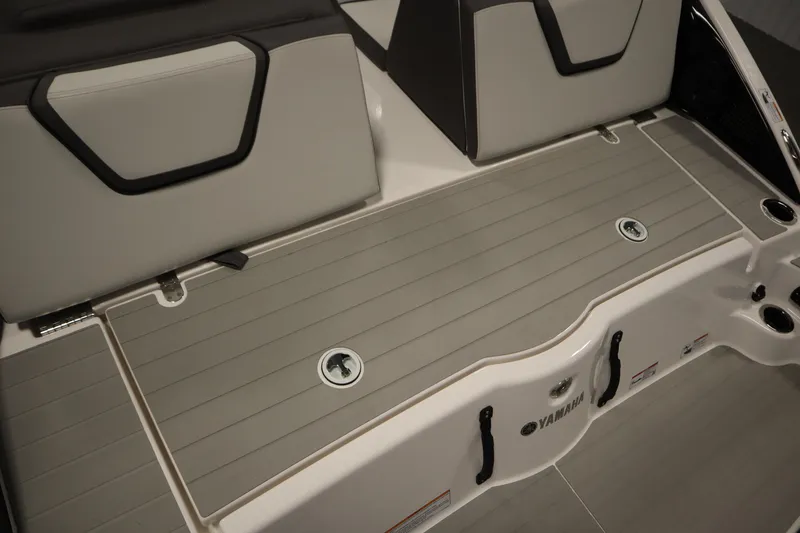 Slide: The Image of 2026 Yamaha Boats AR250 swim platform with gray decking and storage compartments. - 41