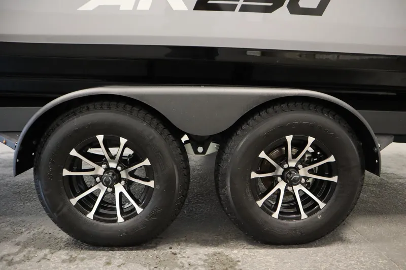 Slide: The Image of 2026 Yamaha Boats AR250 trailer wheels with sleek black and silver rims. - 48