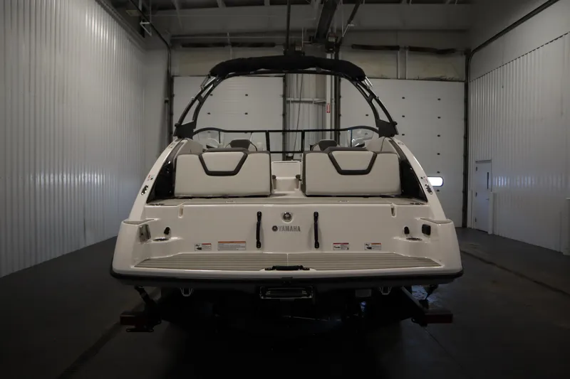 Slide: The Image of 2026 Yamaha Boats AR250 in a warehouse, rear view showcasing sleek design. - 5