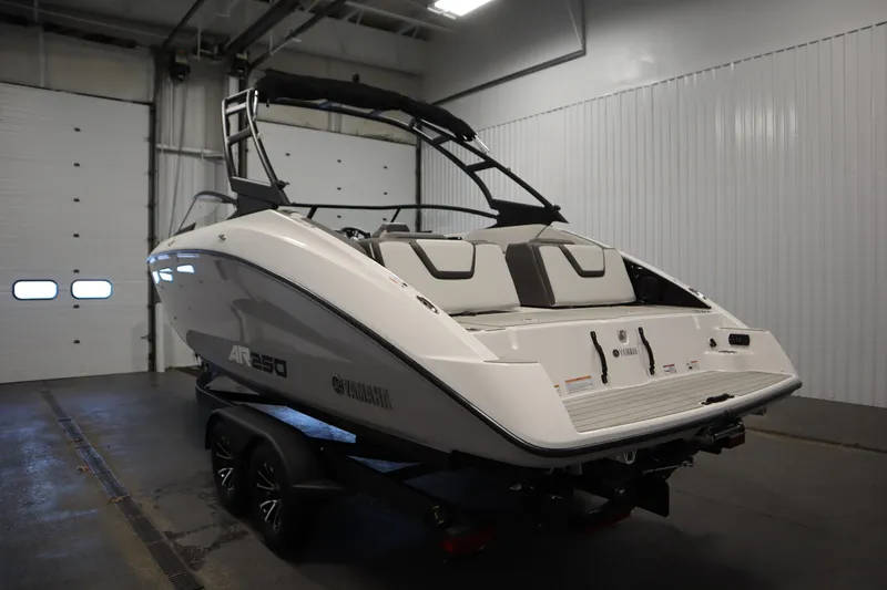 Slide: The Image of 2026 Yamaha Boats AR250 in a garage, showcasing sleek design and modern features. - 6