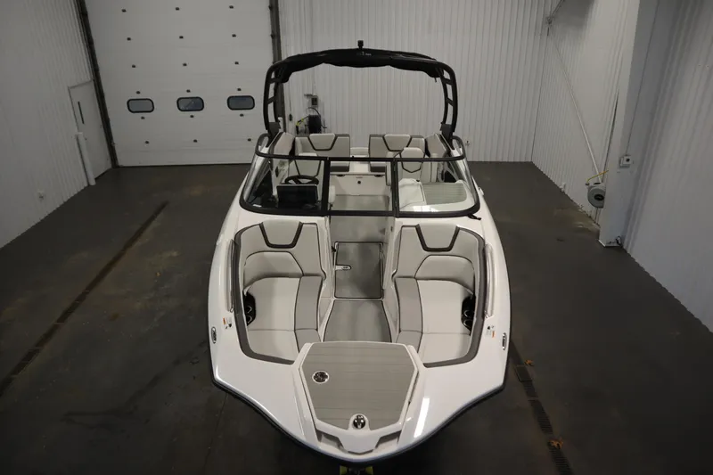Slide: The Image of 2026 Yamaha Boats AR250 in a garage, showcasing sleek design and spacious seating. - 8