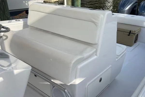 Slide: The Image of White seating on 2013 Bahama 41 Open Fisherman boat, featuring sleek design and storage. - 12