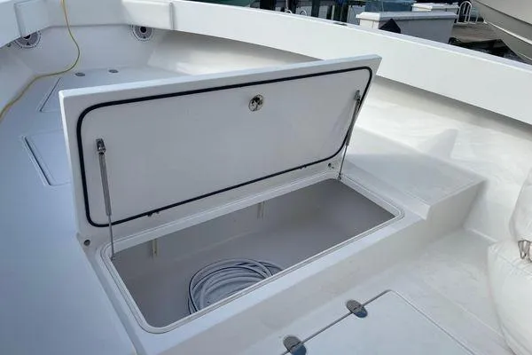 Slide: The Image of Open storage compartment on 2013 Bahama 41 Open Fisherman boat deck. - 16
