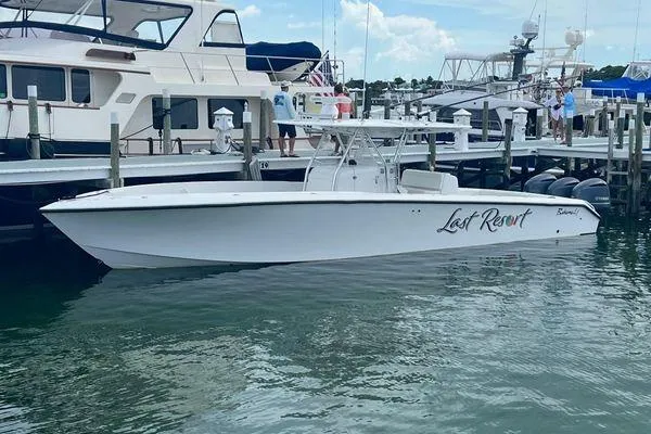 Slide: The Image of 2013 Bahama 41 Open Fisherman boat docked at marina, named "Lost Resort." - 24