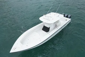 Slide: The Image of 2013 Bahama 41 Open Fisherman boat on water, featuring triple outboard engines. - 27