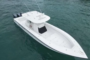 Slide: The Image of 2013 Bahama 41 Open Fisherman boat on water, featuring triple outboard engines. - 28