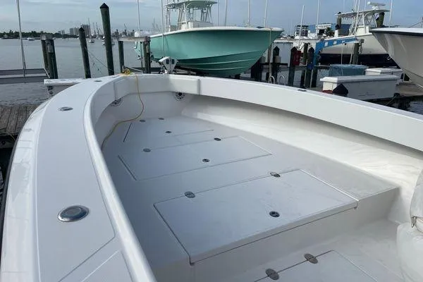 Slide: The Image of 2013 Bahama 41 Open Fisherman boat docked, showcasing spacious deck and storage compartments. - 3