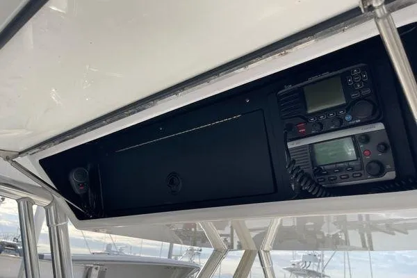 Slide: The Image of 2013 Bahama 41 Open Fisherman boat electronics panel with communication devices. - 6