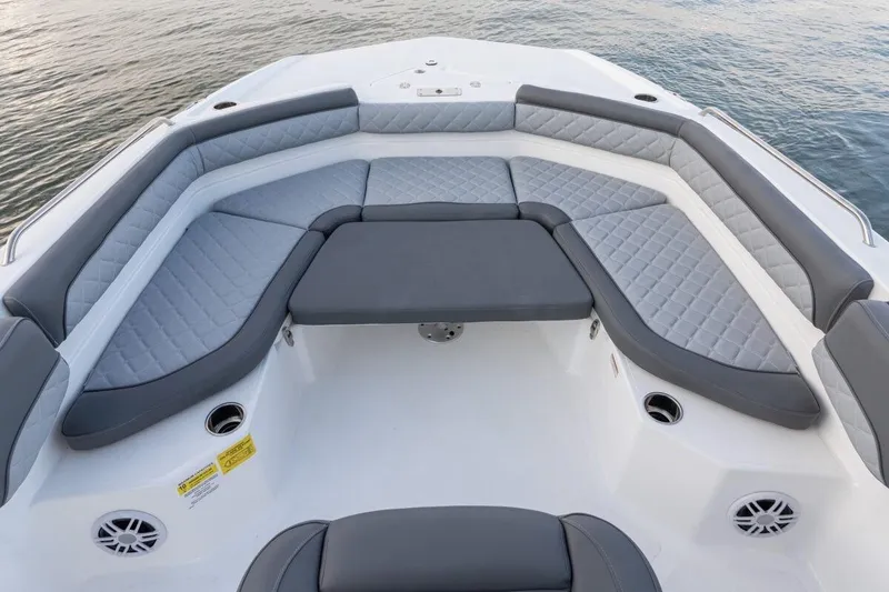 Slide: The Image of 2026 NauticStar 231 Hybrid boat with spacious, cushioned seating and elegant design on the water. - 11